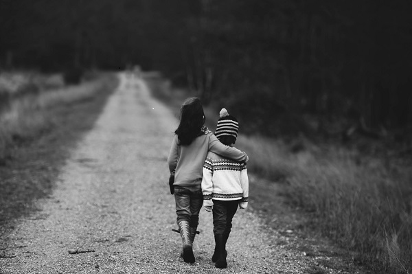 girl walking with arm around another girl