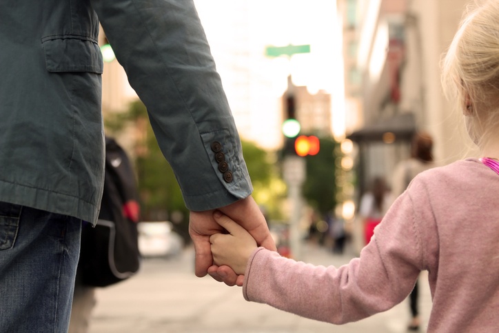 little girl holding father's hand-542332350